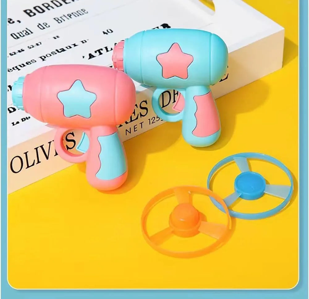 Blue interactive cat toy gun launcher with a mounted pink plastic frisbee, shown with a second frisbee disc.