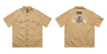Men's black loose-fit cotton blend shirt with chest pocket and embroidered design on half sleeve.