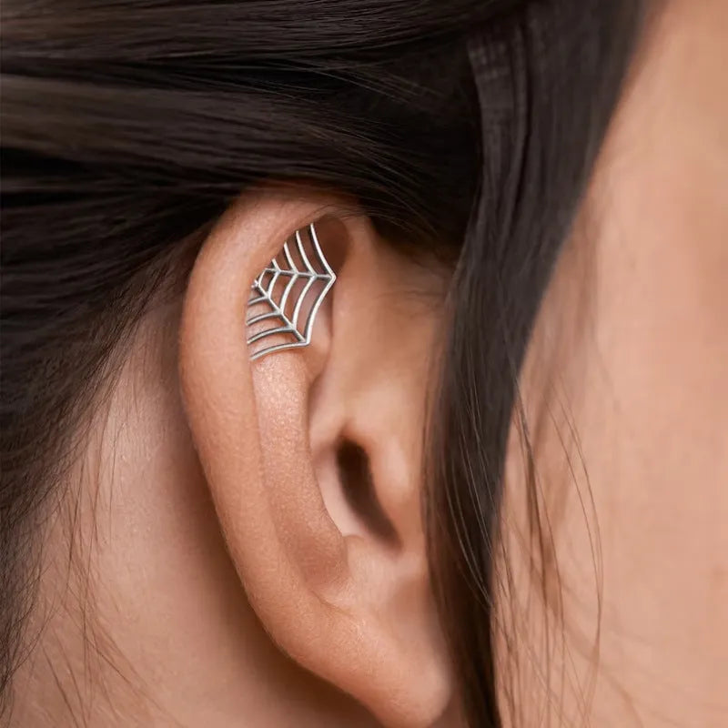 Geometric spider web design stud earrings in gold and silver electroplated metal.