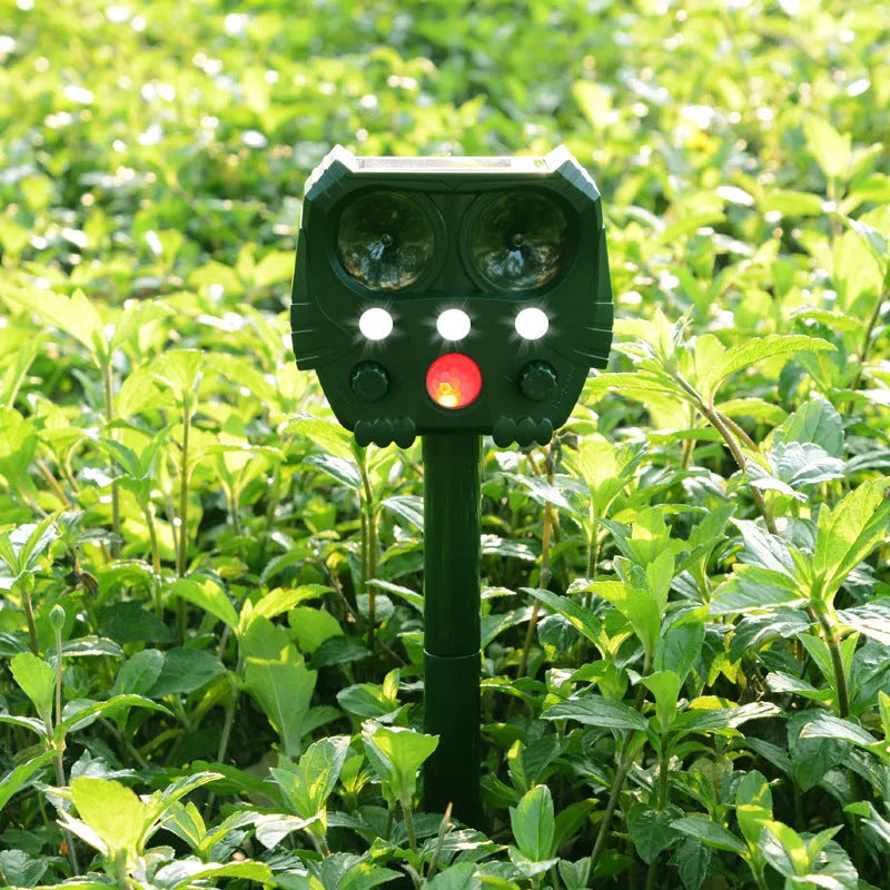 Green solar-powered ultrasonic animal repeller with dimensions 12x13x5cm