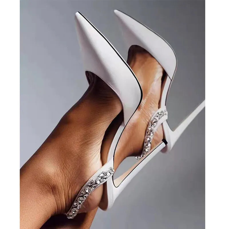 Women's black patent leather pointed toe high heel sandals with rhinestone detail on the side.
