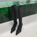 Black women's below knee pointed toe stiletto heel boots with a back zipper