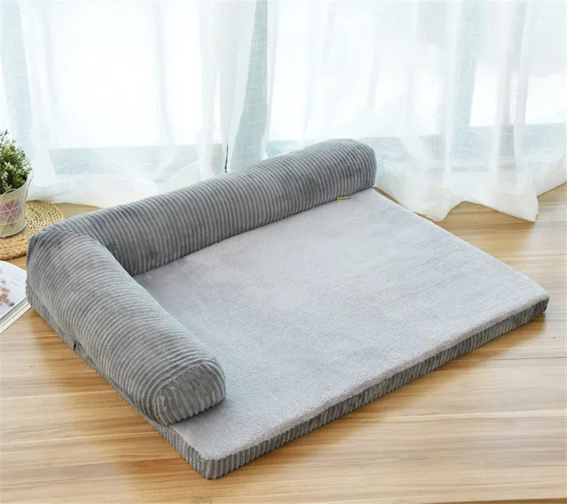Corduroy pet sofa dog bed with bolster in grey colour, showing non-slip base and high-density sponge padding