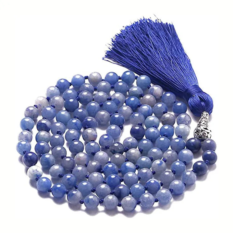 Geometric agate pendant necklace with colourful stone pattern and tassel detail on model