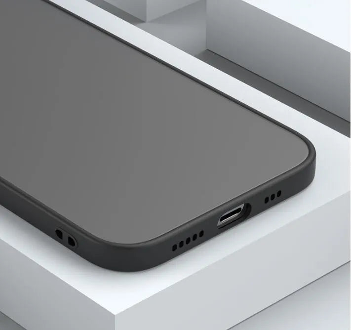 Black frosted hard iPhone case with full camera lens cover and fine hole skin-sensing design on a table.