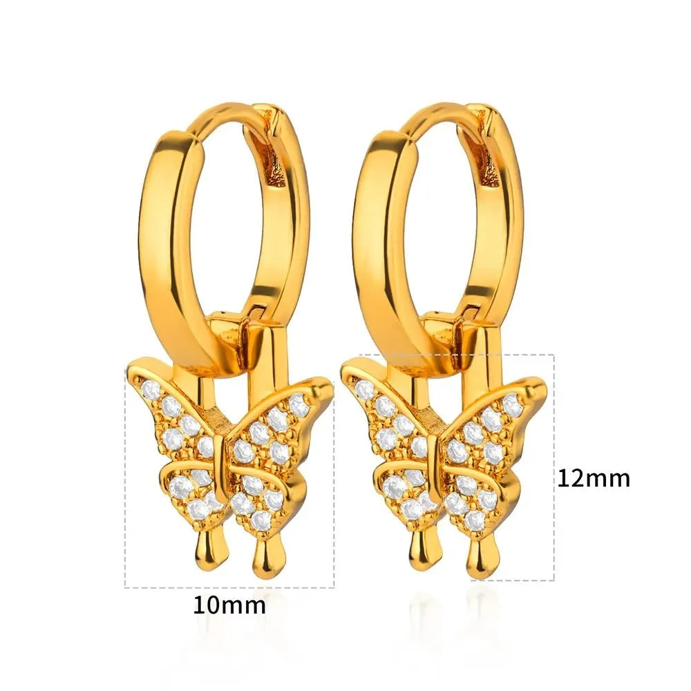A pair of women's geometric butterfly earrings made from copper with heart, bow, and star shapes in a gold colour finish.