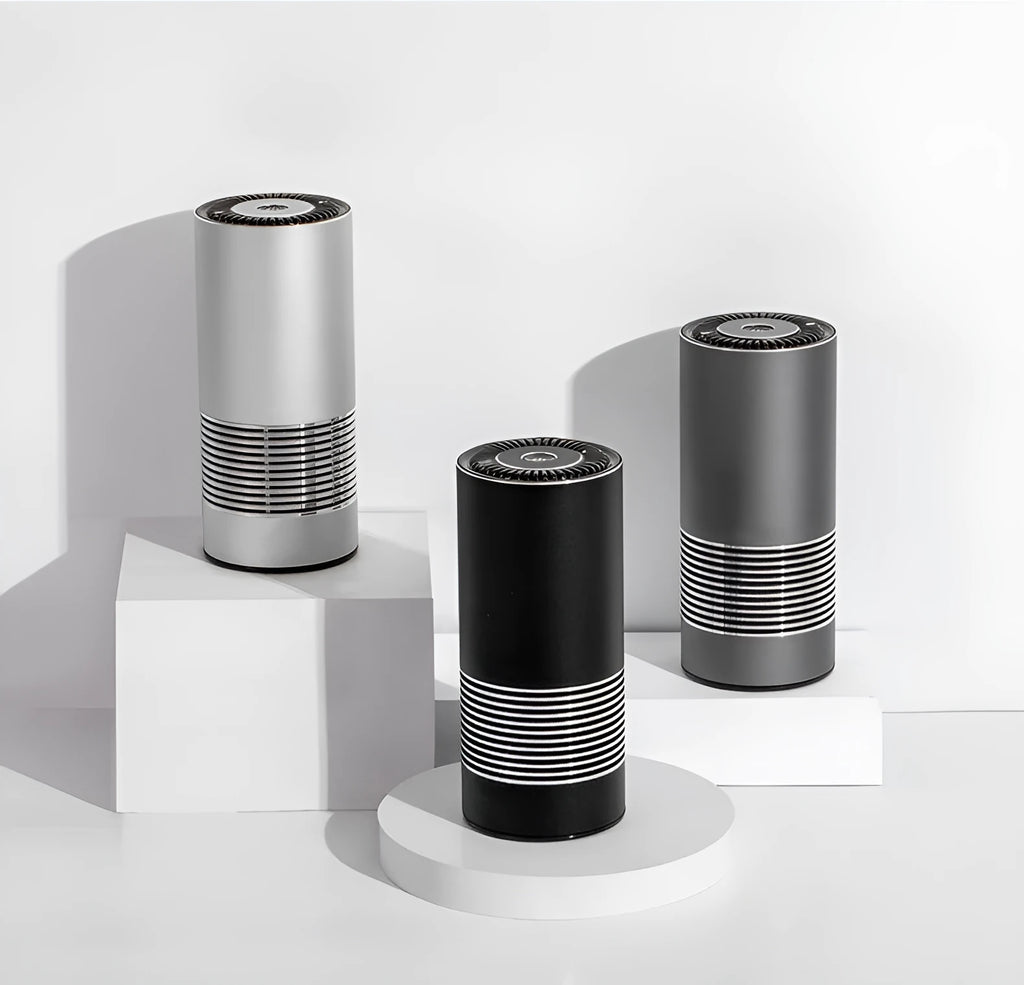 Compact metallic car air purifier on a dashboard with Black, Silver, and Grey colour options.