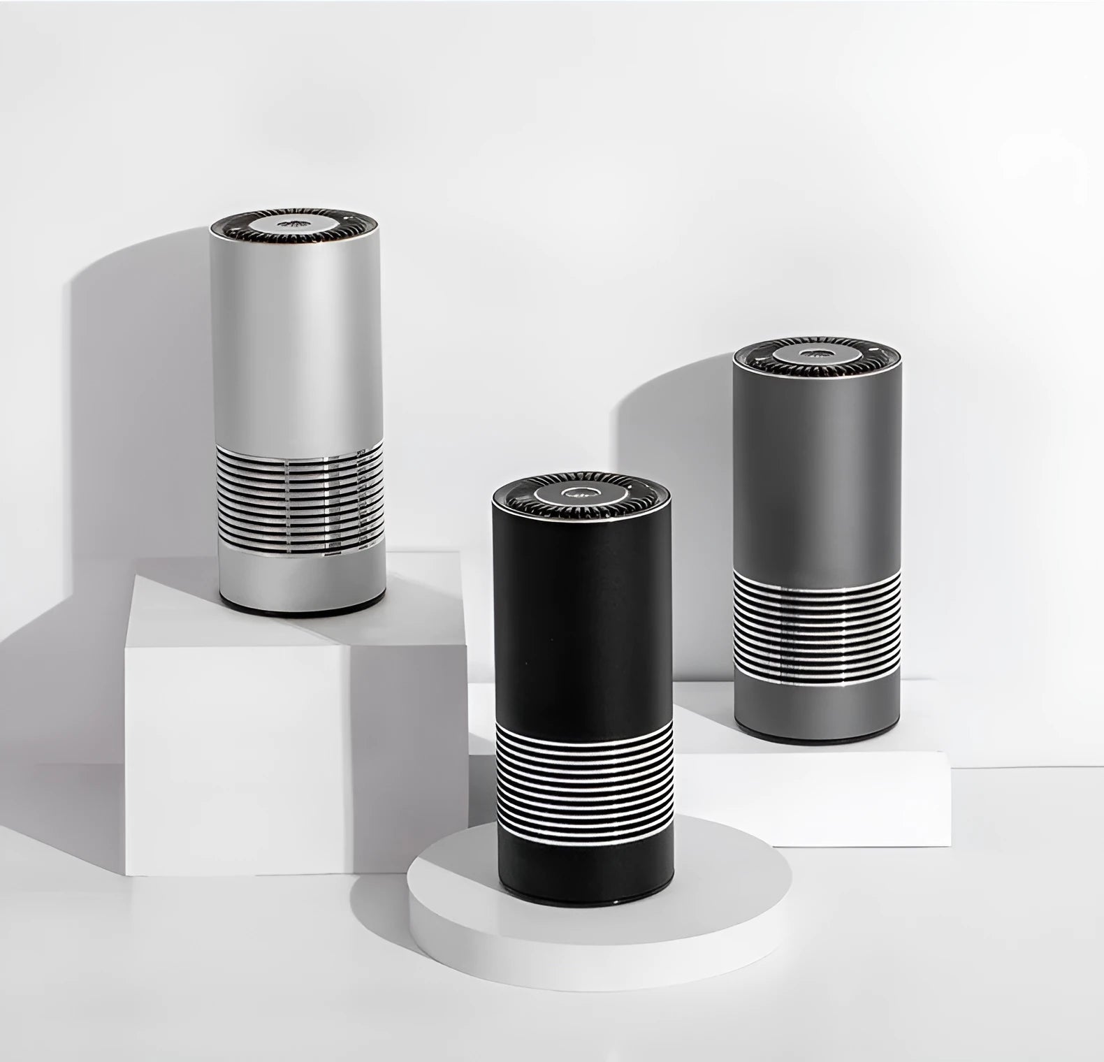Compact metallic car air purifier on a dashboard with Black, Silver, and Grey colour options.