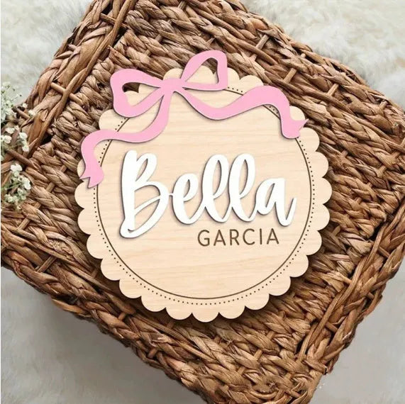 Square wooden baby room ornament with customised name engraving, shown in two size options.