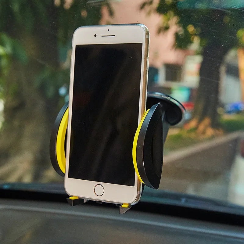 Red ABS plastic car phone holder with U-shaped clamp and suction cup mount on a dashboard.
