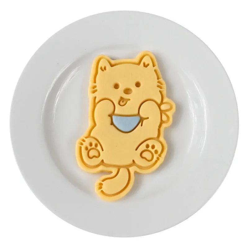 Plastic 3D biscuit mould with cartoon puppy designs including birthday hats and swimming rings