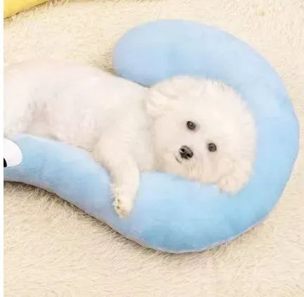 Blue cloth cat sleeping mat in a question mark shape with a U-shaped neck support pillow edge.