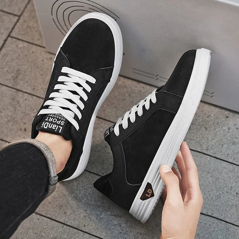Men's black snake pattern leather low-top sneakers with round toe and flat rubber sole.