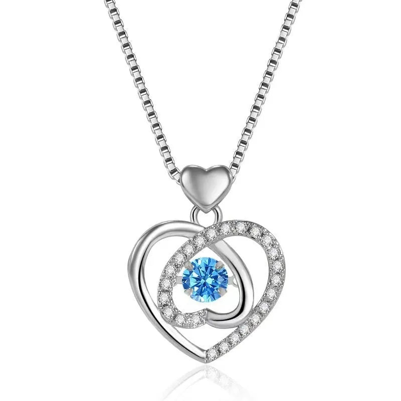 Blue diamond electroplated heart necklace and bracelet set with gem inlay on a geometric pendant.