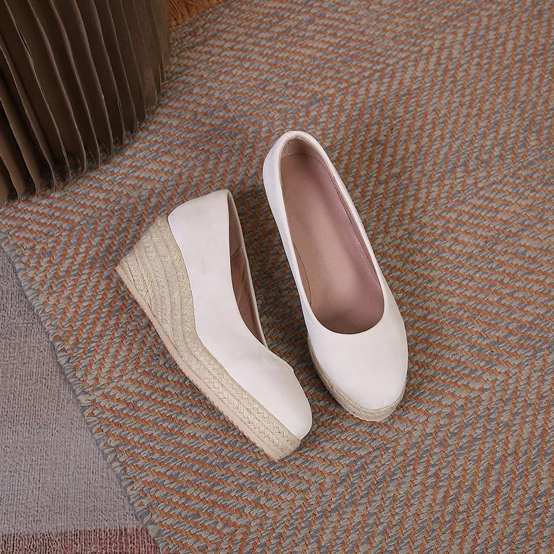 Women's apricot wedge heel pumps with rope detail on heel and round toe.
