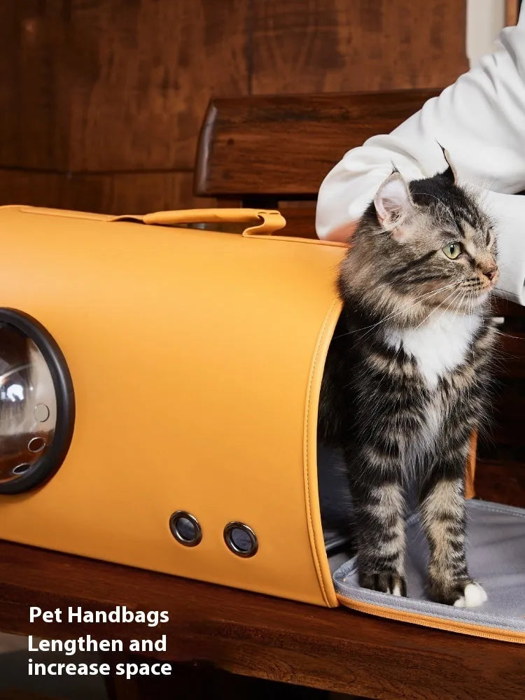 Portable pet carrier bag for cats and small dogs, shown in elk orange colour with shoulder strap.