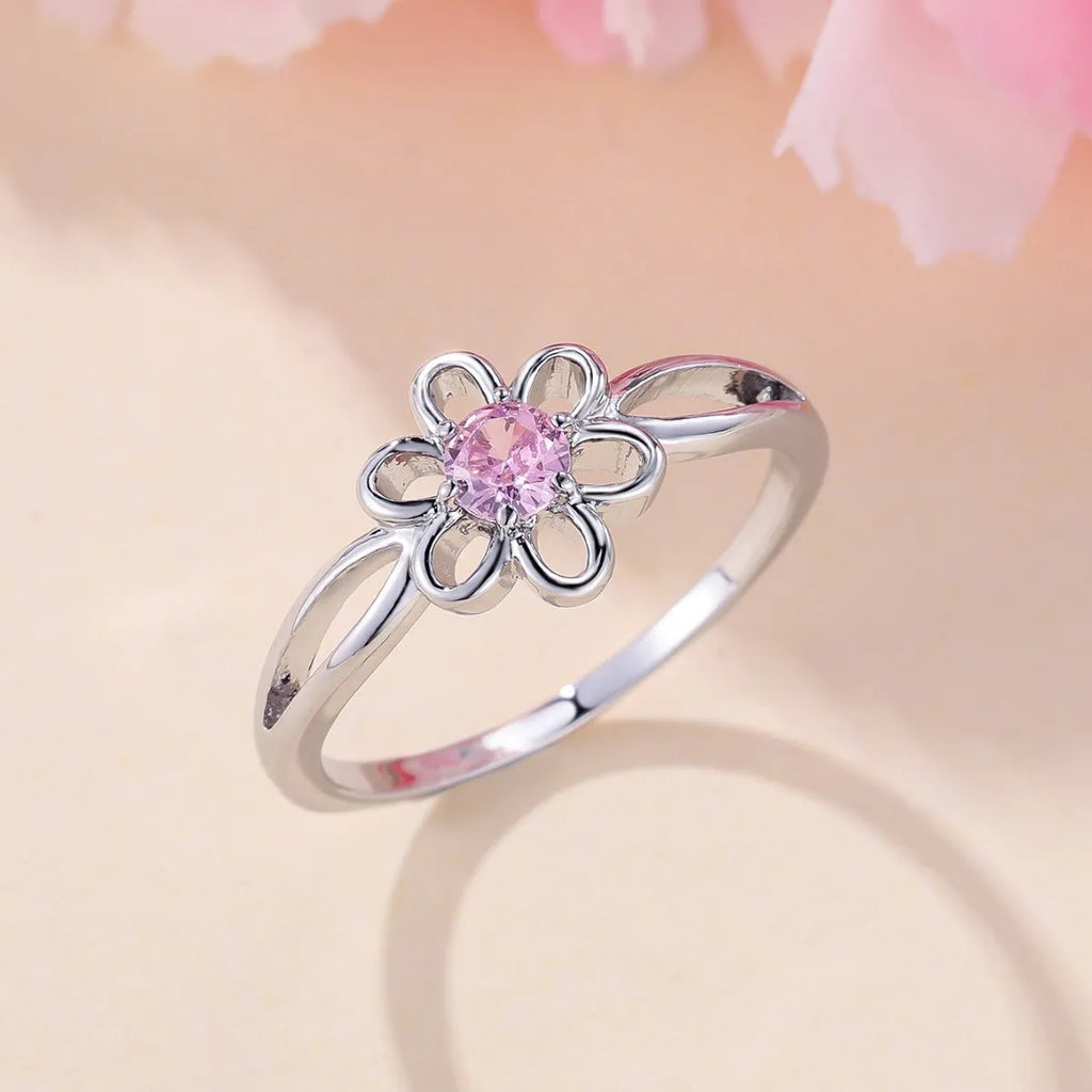 Women's hollowed floral copper ring with electroplated platinum pink diamond finish