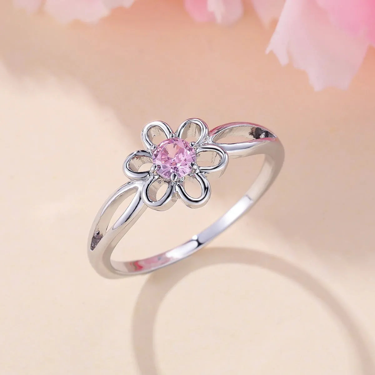 Women's hollowed floral copper ring with electroplated platinum pink diamond finish