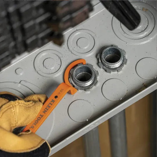Orange, grey, and black crescent wrenches from a three-piece magnetic suction set for catheter locking.