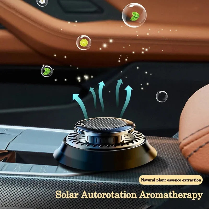 Solar powered kinetic car air freshener with double rotating rings on car dashboard