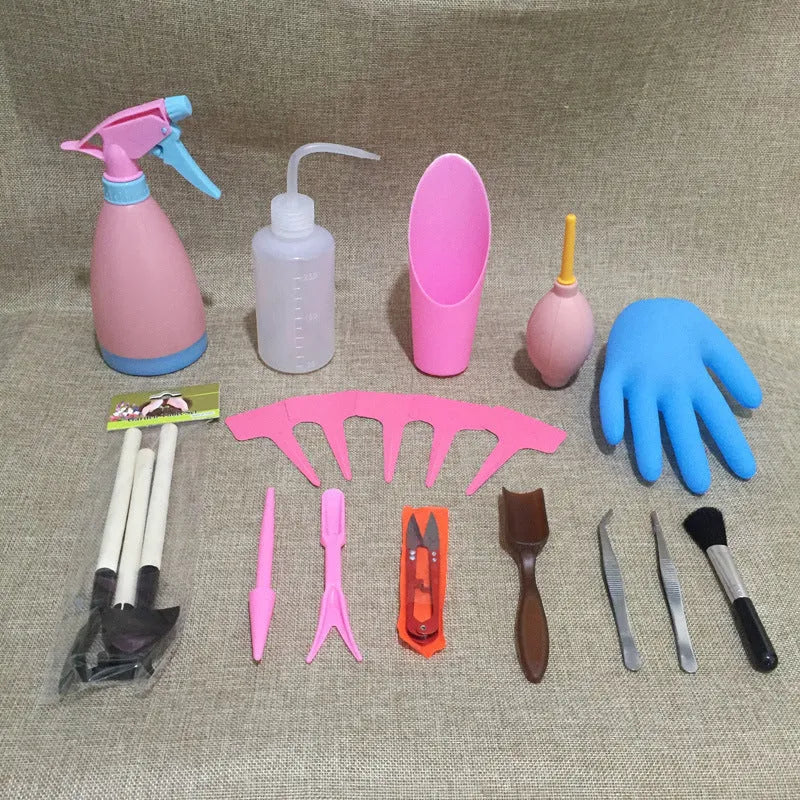 Succulent gardening tool set showing mini shovel, watering can, tweezers, brush, and rake on a table