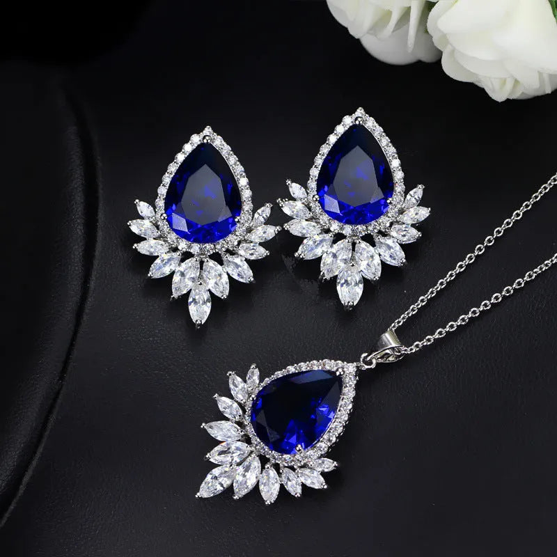 Bridal jewellery set with necklace and earrings in blue, red, or white crystals for formal banquets.