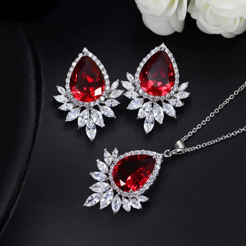 Bridal jewellery set with necklace and earrings in blue, red, or white crystals for formal banquets.