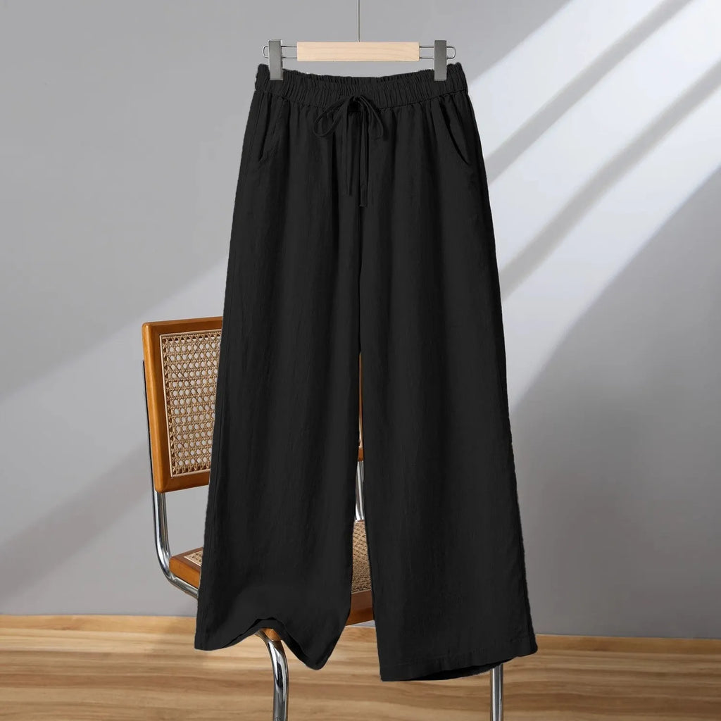 Women's apricot straight-leg casual trousers with a drawstring elasticated waist laid flat.