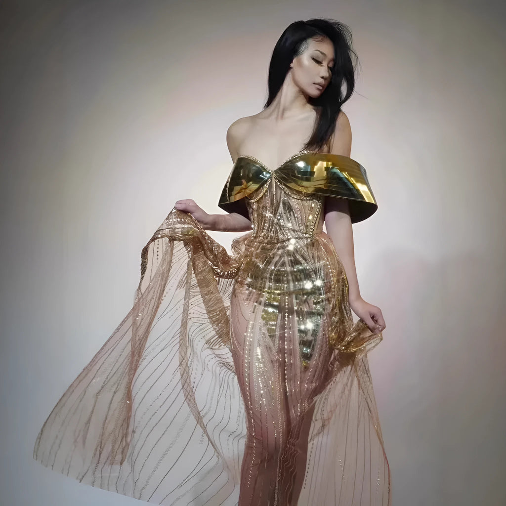 Gold strapless sequin evening dress with a voluminous tulle skirt and a high thigh split.