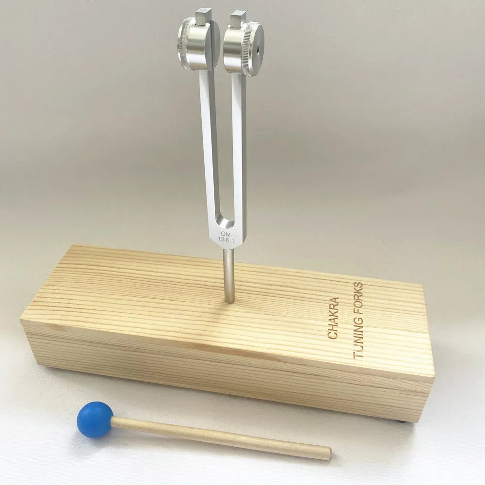 Aluminium alloy 432 Hz tuning fork with a matching speaker unit on a kraft paper box.
