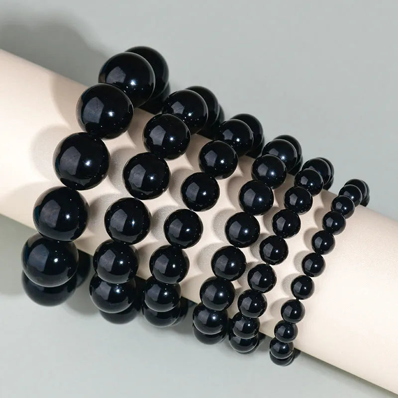 Hand-woven obsidian bracelet with round crystal beads in multiple colour options and sizes