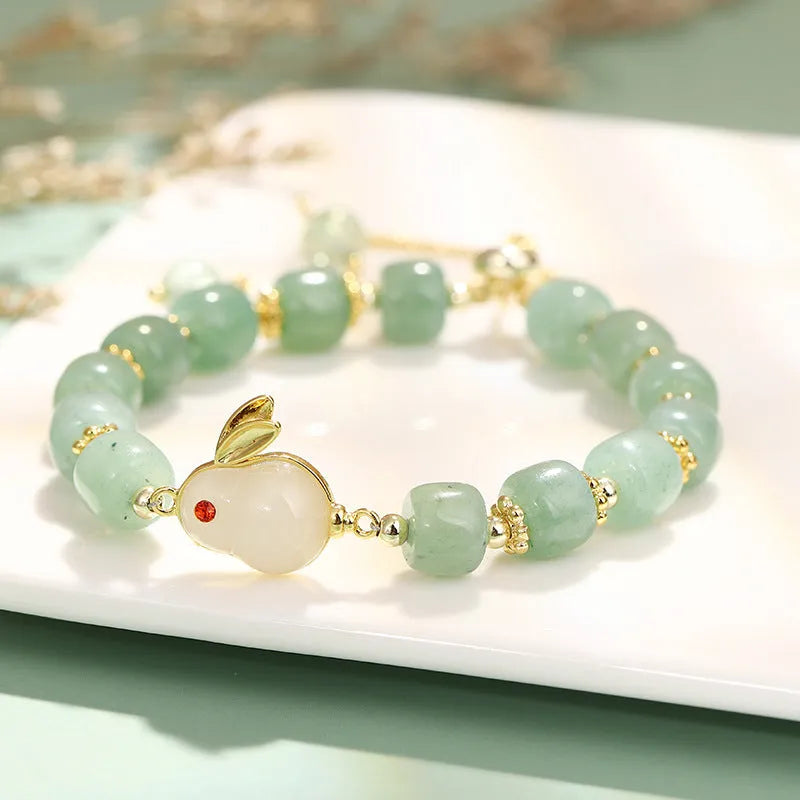 Rabbit motif bracelet with green aventurine and strawberry quartz stones in gold and copper setting