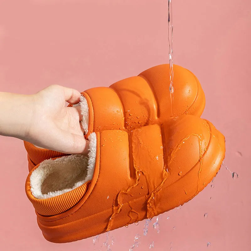 A pair of waterproof EVA couple slippers with a plush lining, shown in a choice of colours like green, pink, or grey.