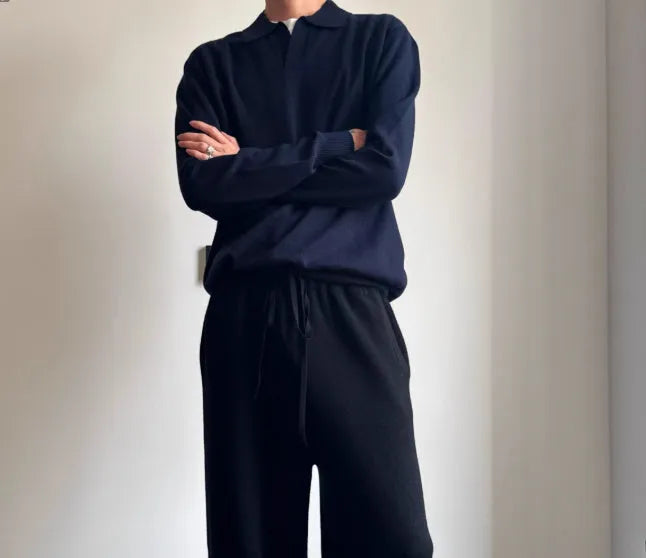 Man wearing a milky white pure wool polo sweater with a lapel collar in a loose fit.