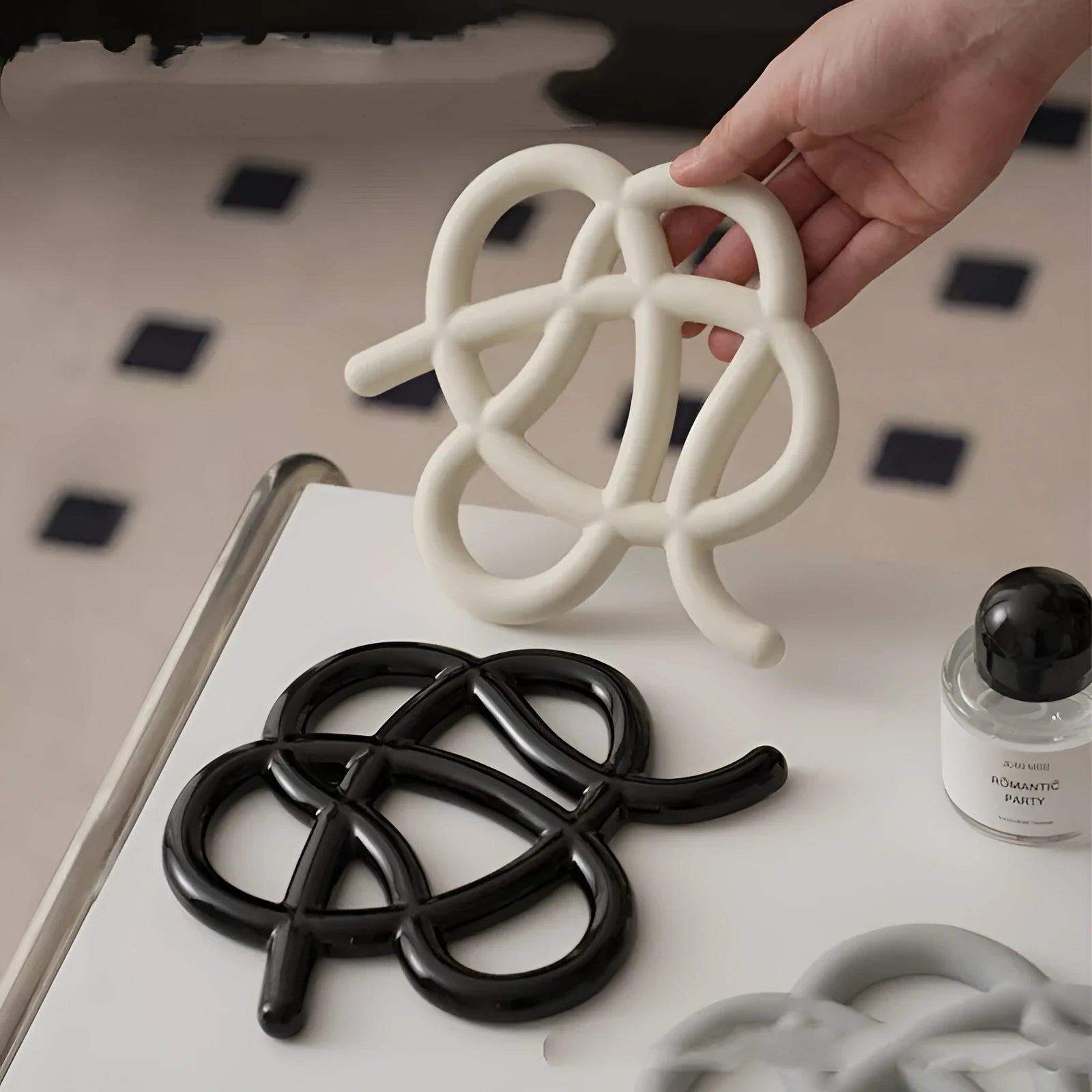 Ceramic heat proof mat in an irregular shape on a kitchen countertop.