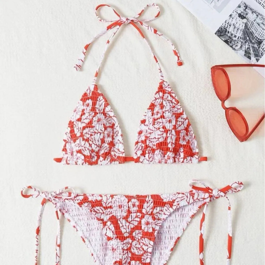 Women's pink floral halter neck bikini swimsuit with briefs on a mannequin.