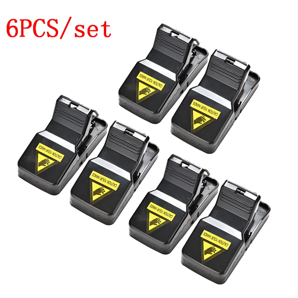 Six black plastic snapping mousetraps showing size and smooth surface.