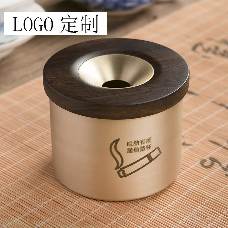 Brass ashtray with wooden lid featuring centre hole design