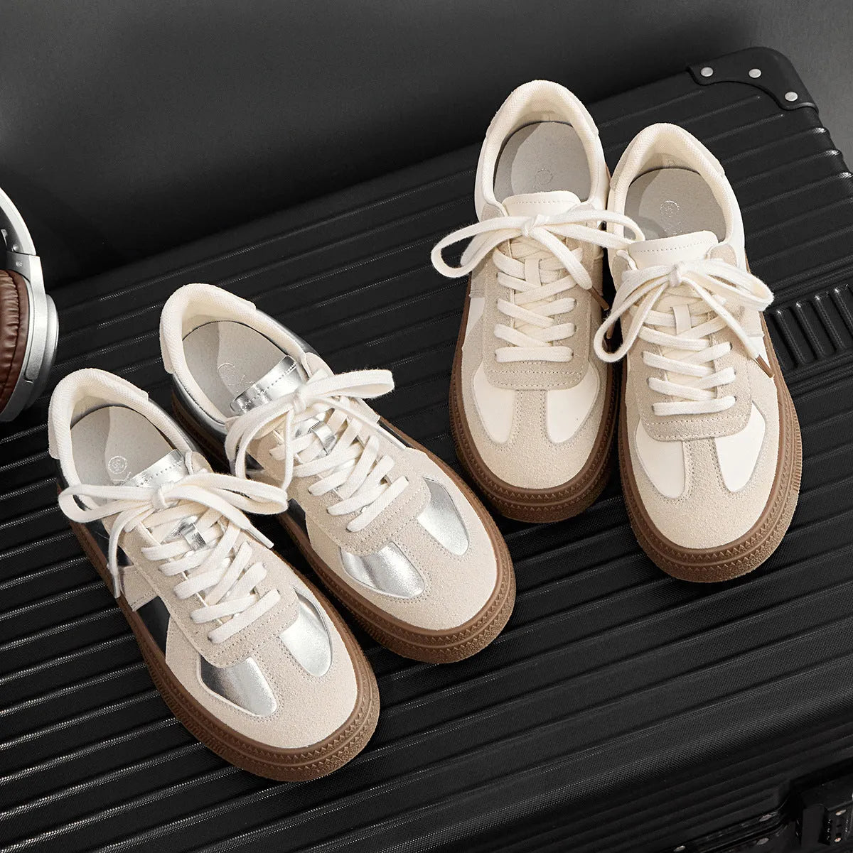 Retro-style silver board shoes with cross straps and round toe on a rubber sole.