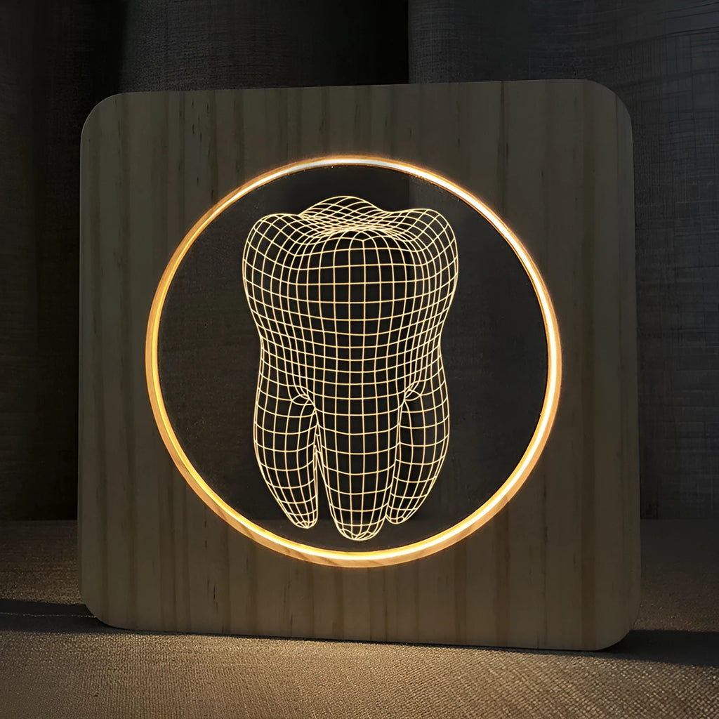Wood-coloured tooth-shaped acrylic night lamp with USB cable on a surface.