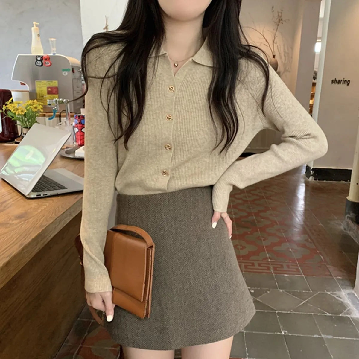 Women's beige loose-fit viscose knitted cardigan top with long sleeves shown worn open.