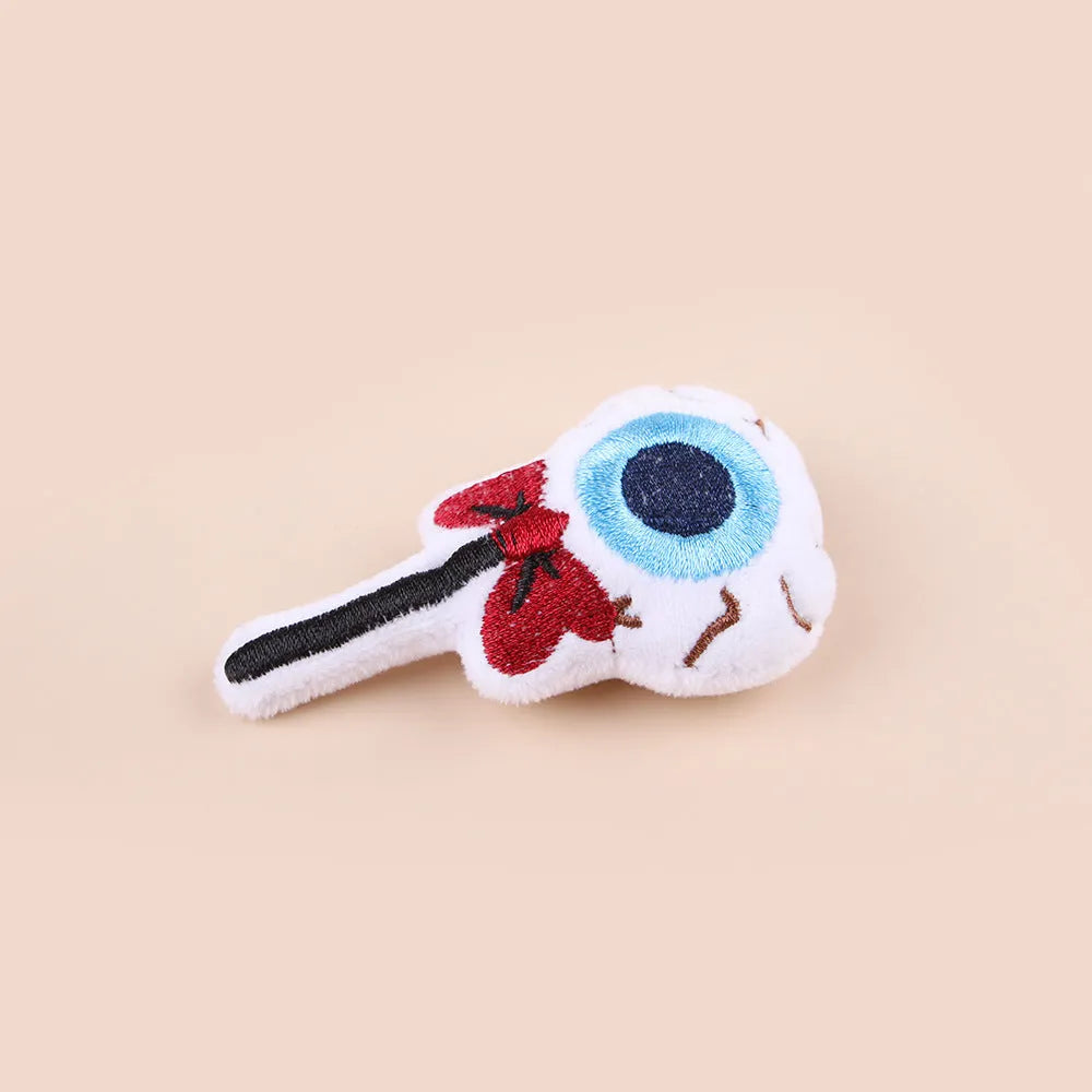 Small colourful plush cat teaser toy with candy, eyes and skull attachments