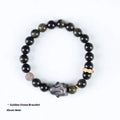 Handmade lying rabbit obsidian bracelet with grey agate beads and brass details on a wrist.