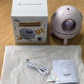 Purple astronaut-shaped USB desktop humidifier with LED lights on a desk