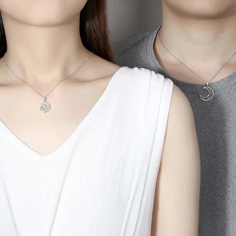 Sun Moon Tooth couple necklace set showing male and female copper pendants on cross chains