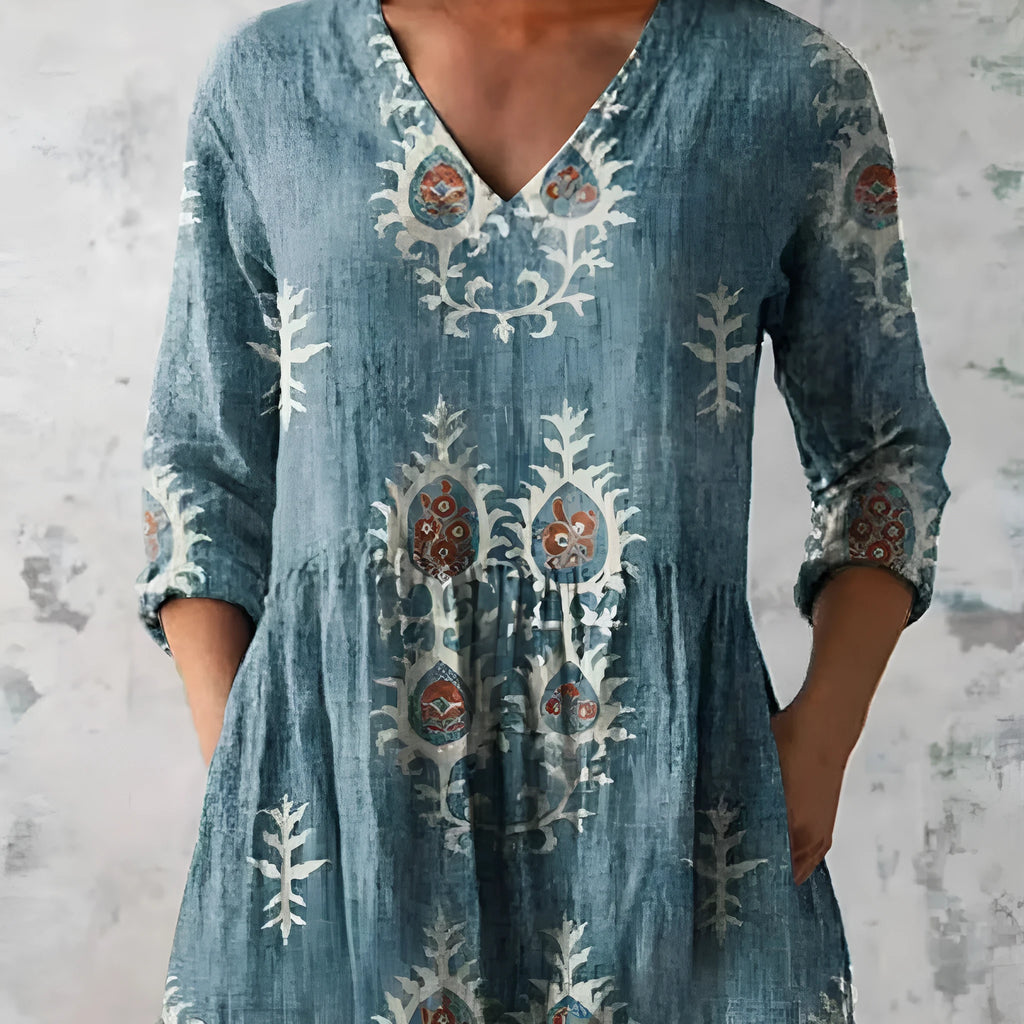 Women's loose-fitting printed dress with 3/4 sleeves and a wide waist design.