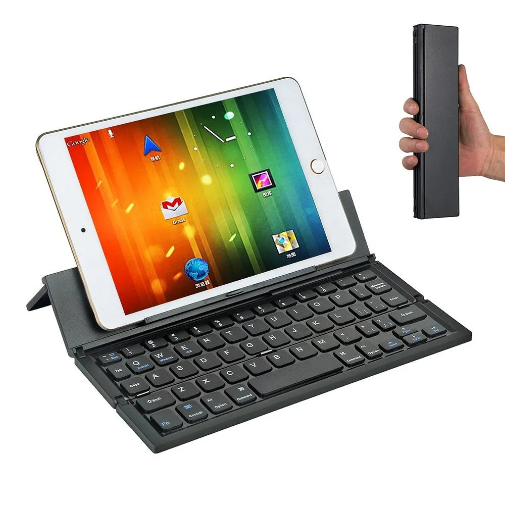 Black folding Bluetooth keyboard unfolded next to tablet showing ultra-thin design