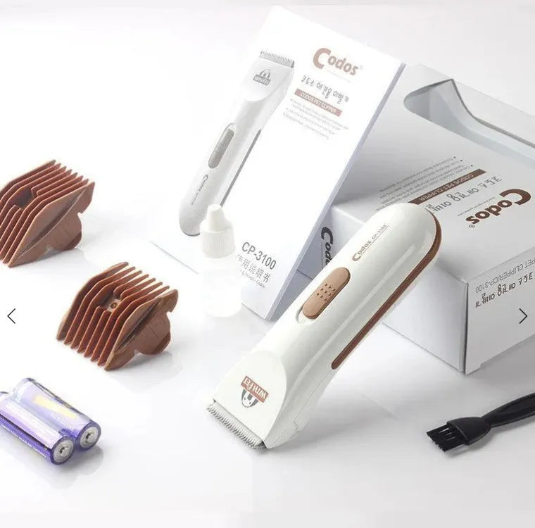 White electric pet hair clipper with ceramic blade on a table