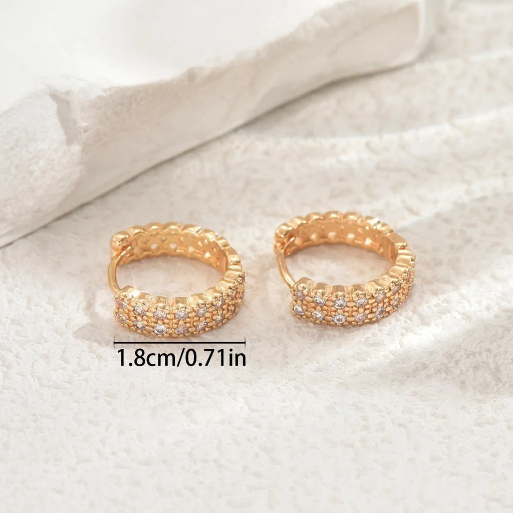 Geometric copper ear studs with circular dot and ring patterns in colour DE20288