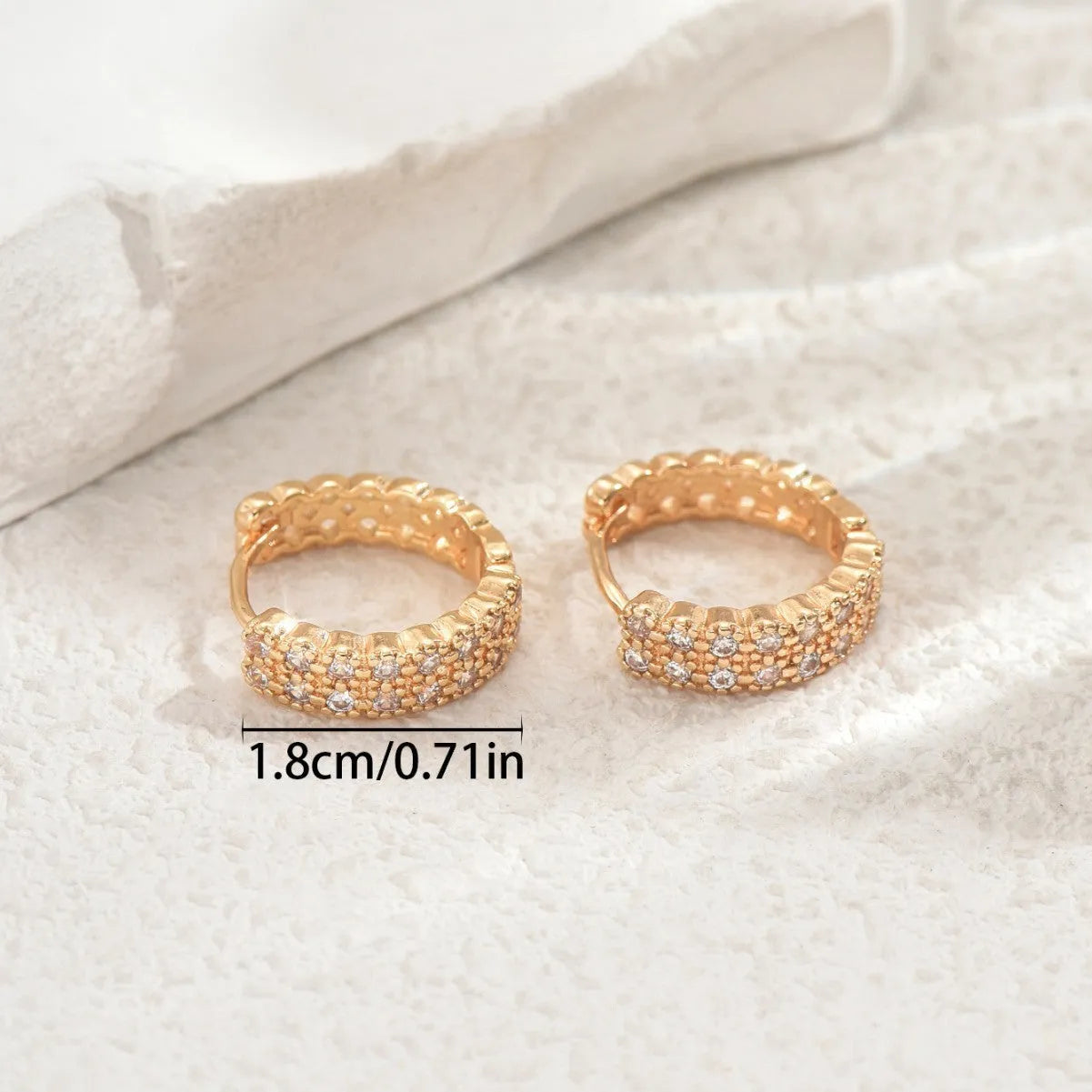 Geometric copper ear studs with circular dot and ring patterns in colour DE20288